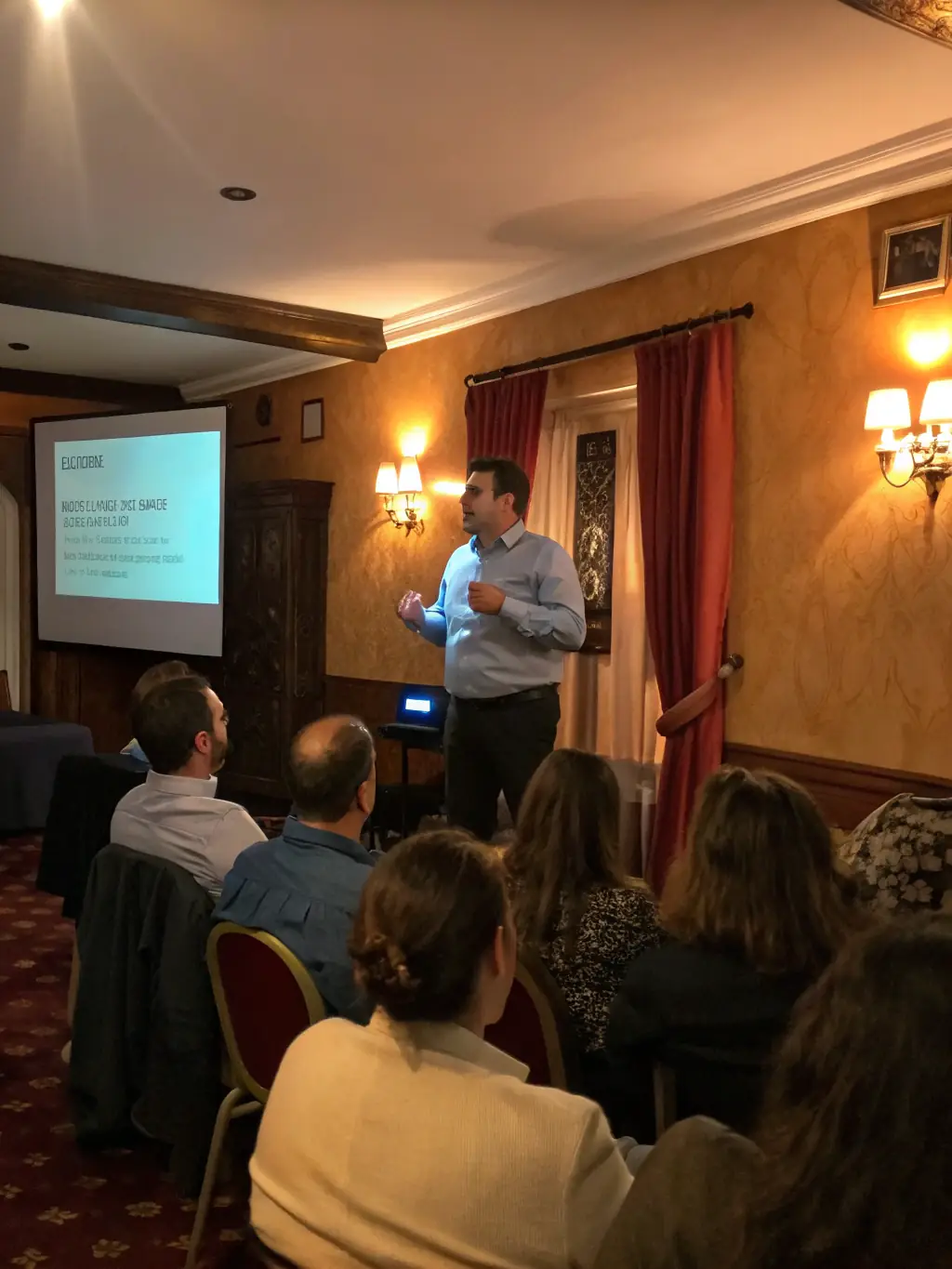 A photograph of a lecture in progress, with an expert speaker discussing the architectural history of Parisian townhouses.